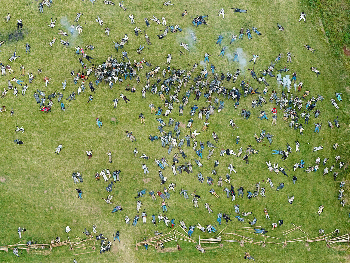 Dead confederate bodies litter a battlefield re-enactment.